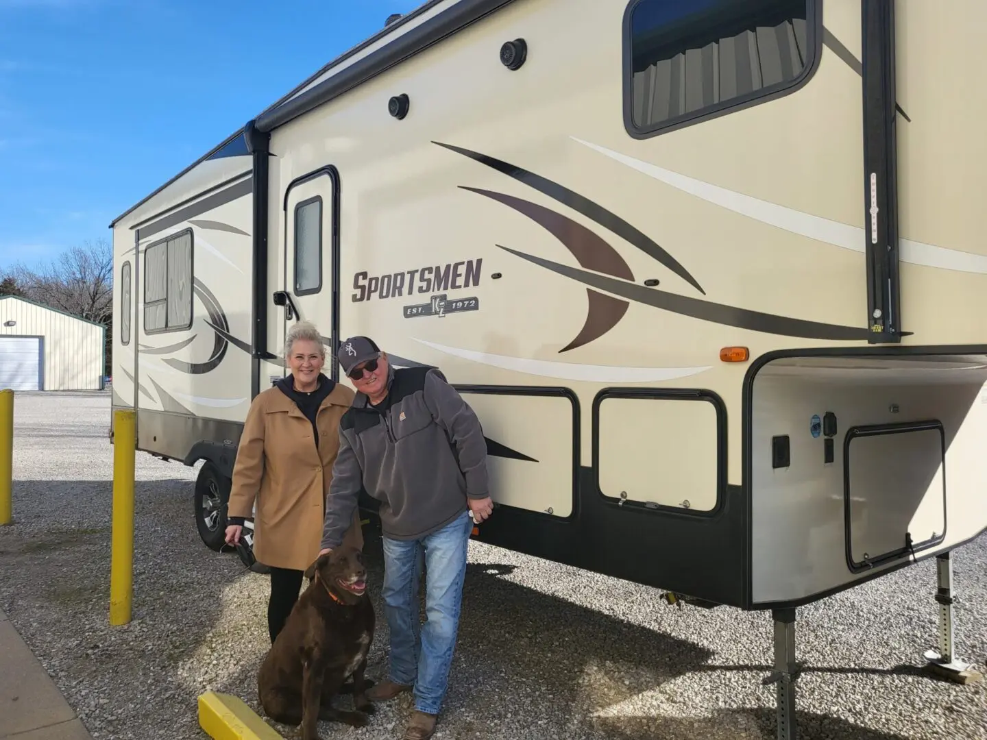 Couple with dog beside RV