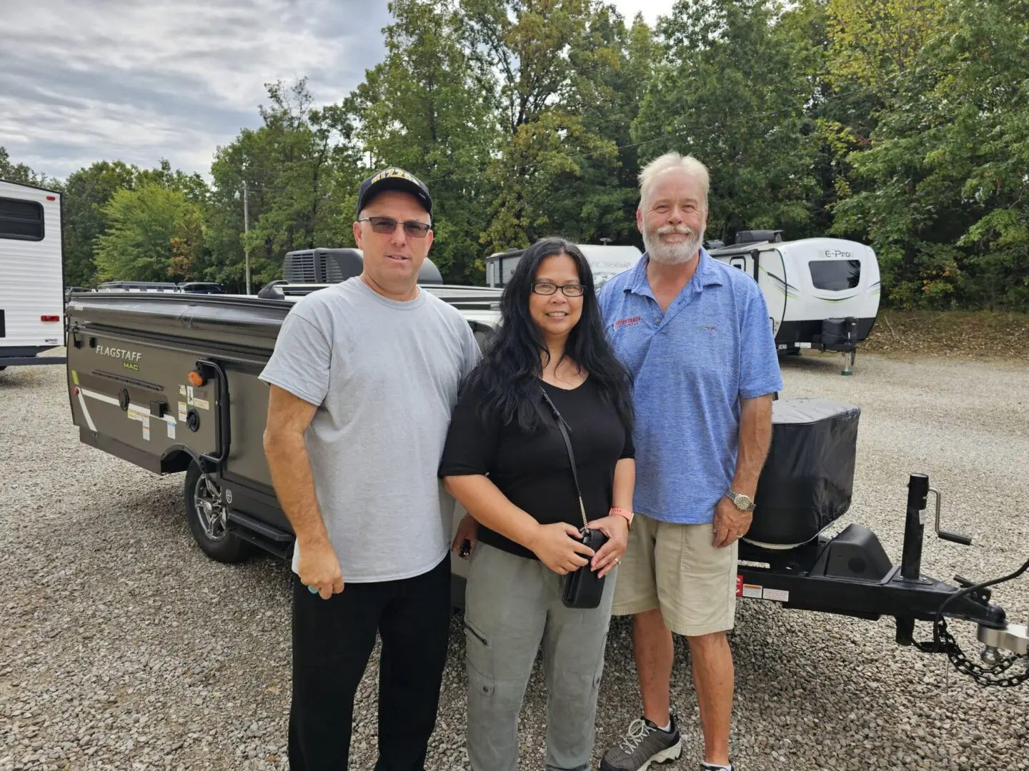 Group posing in front of a camper