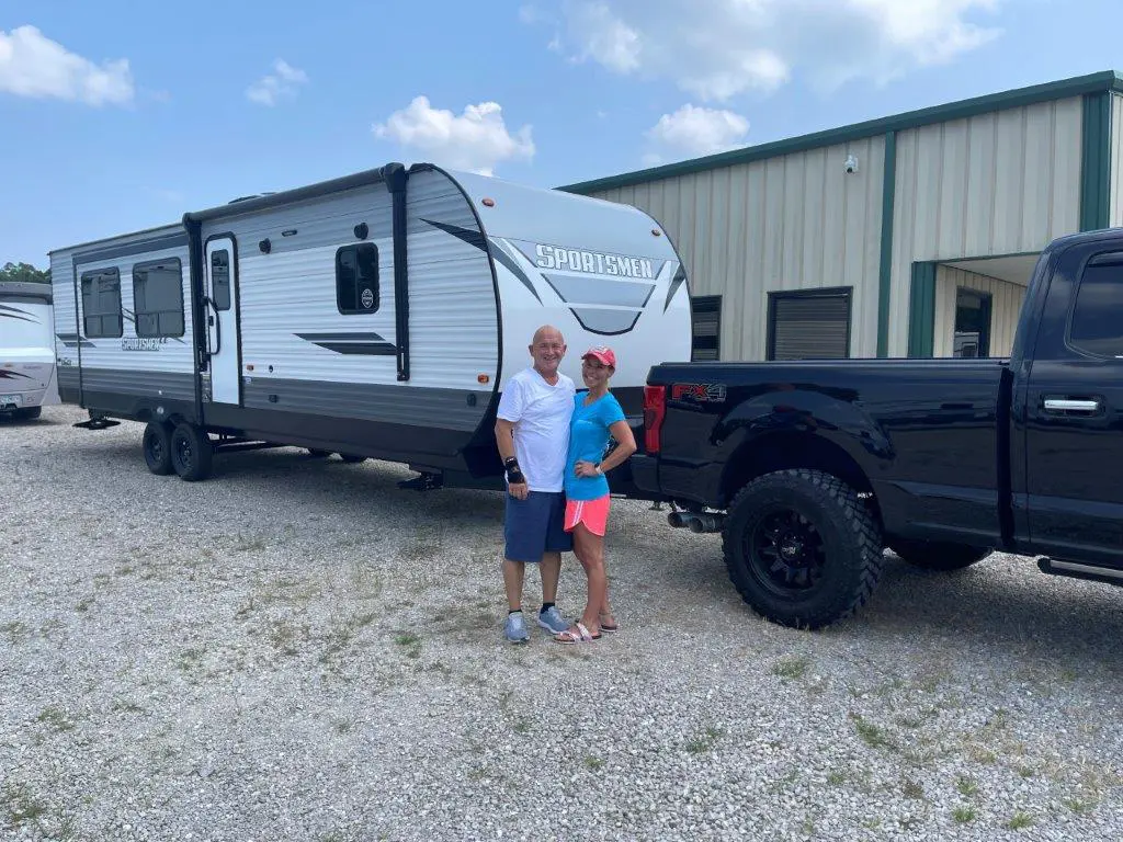 Couple standing by truck and trailer