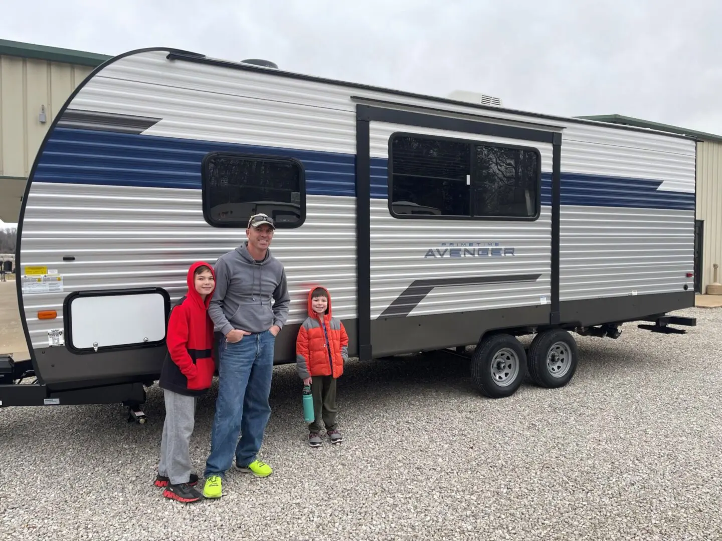 Father and kids next to RV