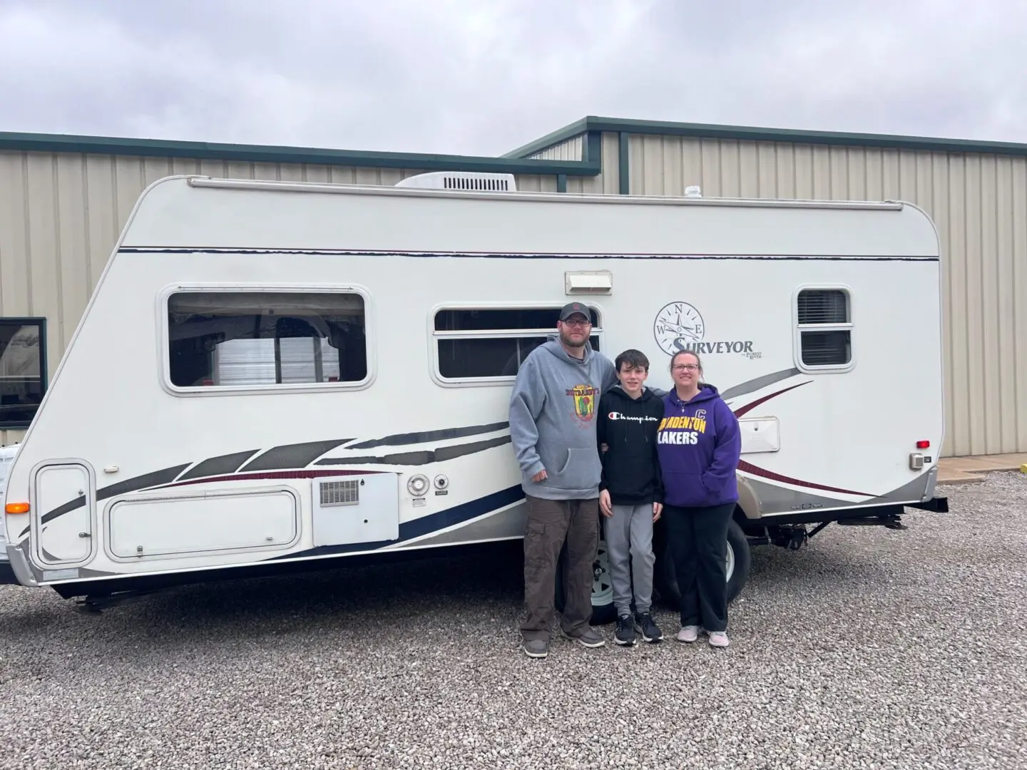 Family standing in front of trailer