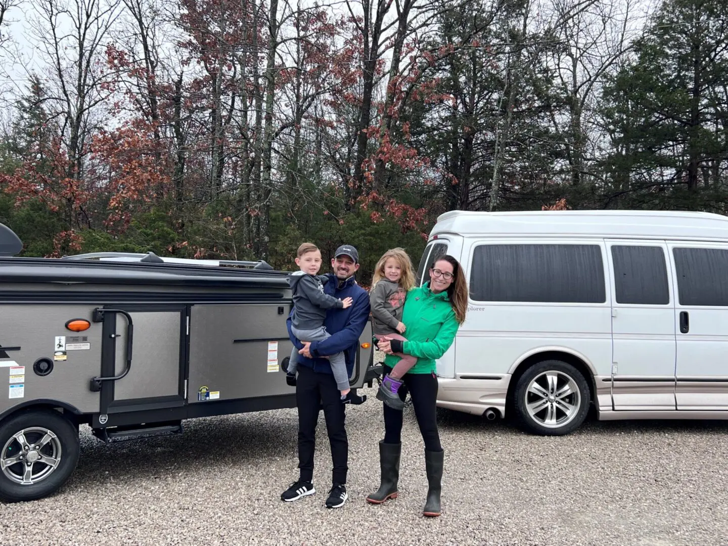 Parents and kids by camper trailer
